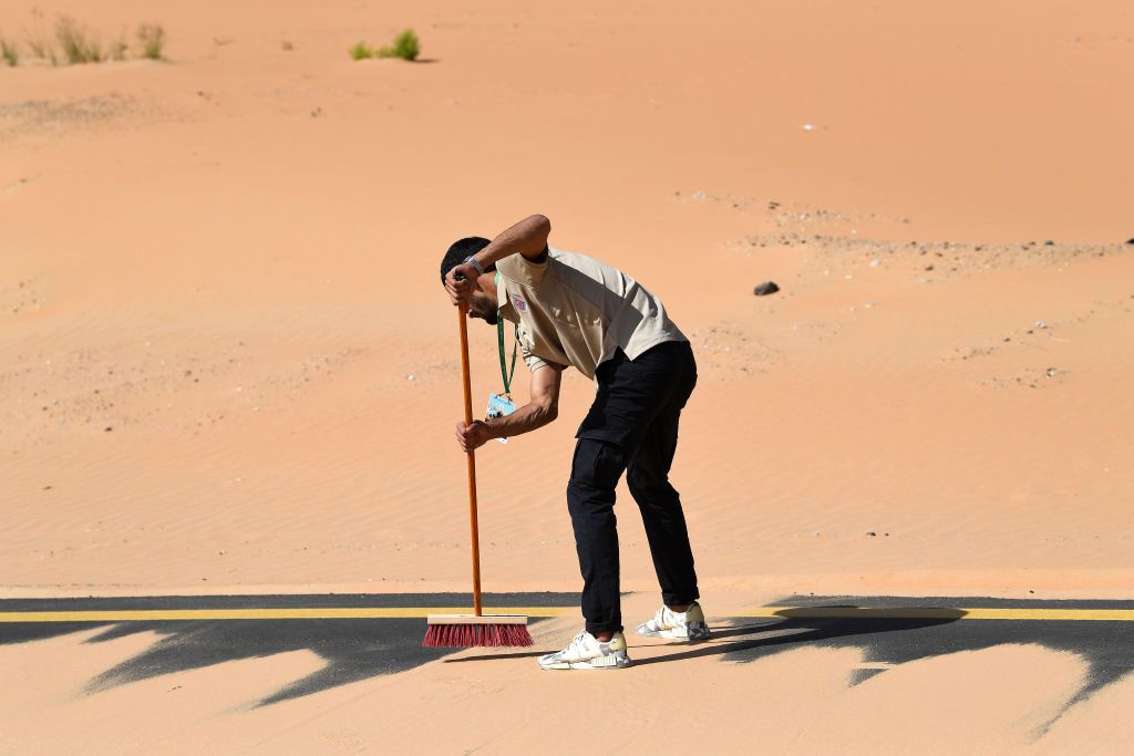 MADINAT ZAYED UNITED ARAB EMIRATES FEBRUARY 20 Race staff cleans the sand over the road during the 4th UAE Tour 2022 Stage 1 a 184km stage from Madinat Zayed to Madinat Zayed UAETour WorldTour on February 20 2022 in Madinat Zayed United Arab Emirates Photo by Tim de WaeleGetty Images