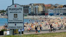 People and families on the beach sunbathing, swimming, playing and generally enjoying the fine sunshine in Margate