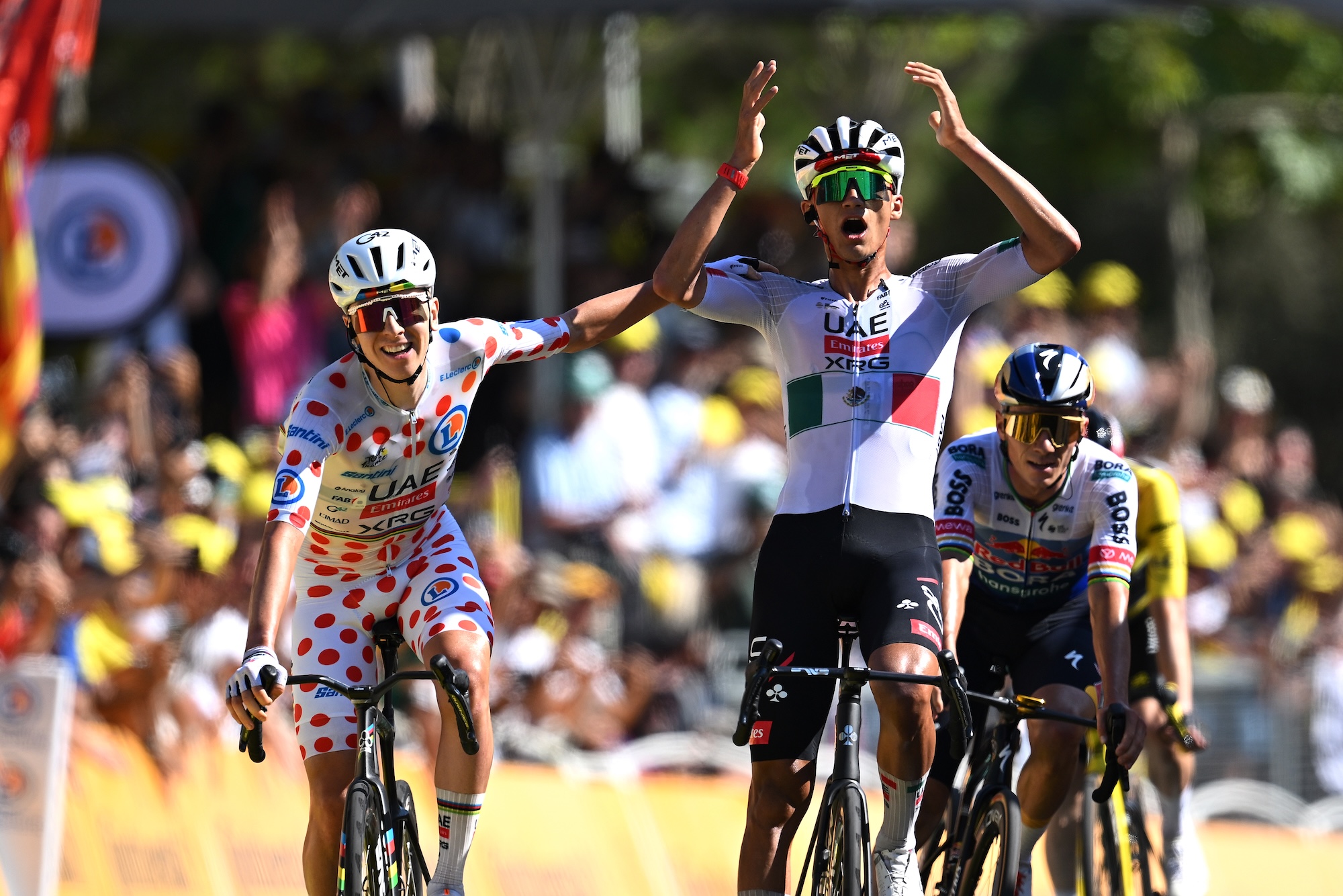 A smiling Pogacar puts a hand on Del Toro's shoulder as he celebrates the stage win