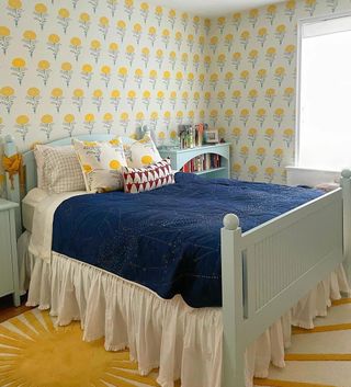 Small bedroom with accents of yellow and blue bed coverlet