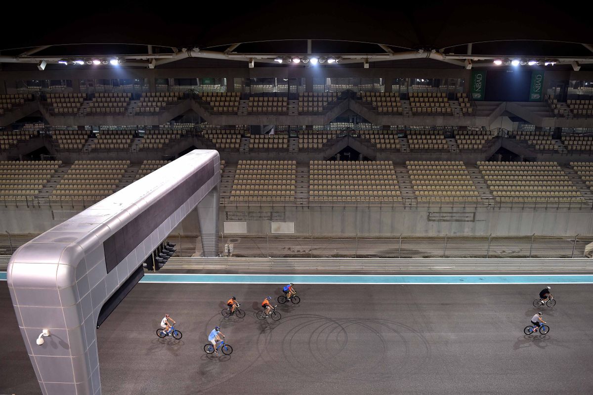 Riders are dwarfed by the F1 venue