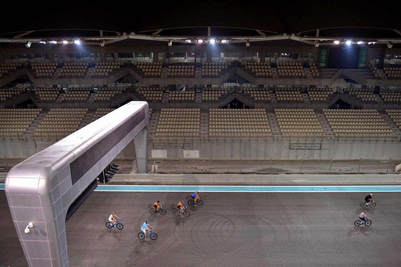 Riders are dwarfed by the F1 venue