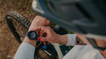 best outdoor watch: Pictured here, a biker looking at the Suunto 9 Peak Pro