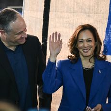 Vice President and Democratic presidential candidate Kamala Harris (R) waves to the audience alongside Second Gentleman Douglas Emhoff during a stop on their campaign bus tour in Rochester, Pennsylvania.