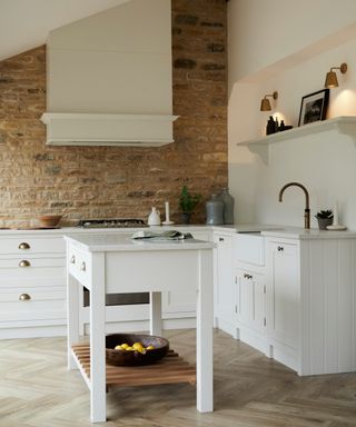 white baker table in white shaker style fitted kitchen