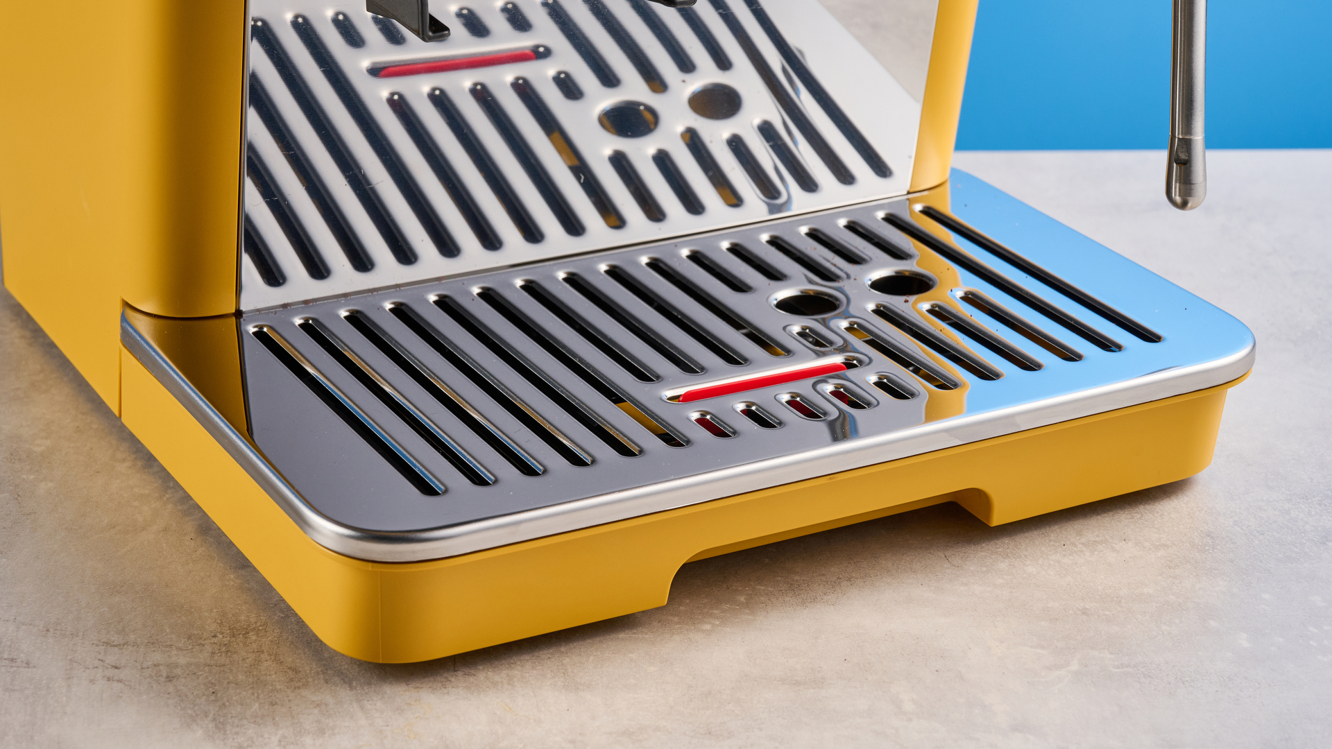 the de&#039;longhi la specialista arte evo special edition truestart edition, with yellow body, showing the espresso machine attachments like tamper, tamping collar, grinder, and control buttons