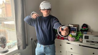 PSVR2- Man using virtual reality headset and controllers.