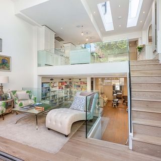 open plan living room with wooden flooring and bi folding doors