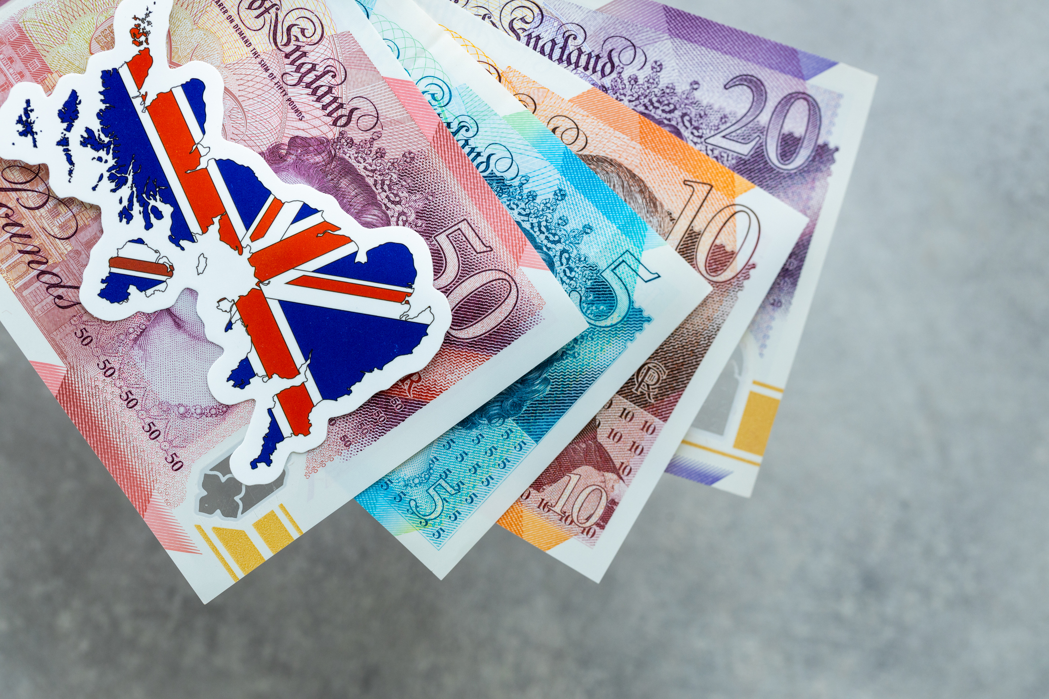 UK map on top of a pile of money