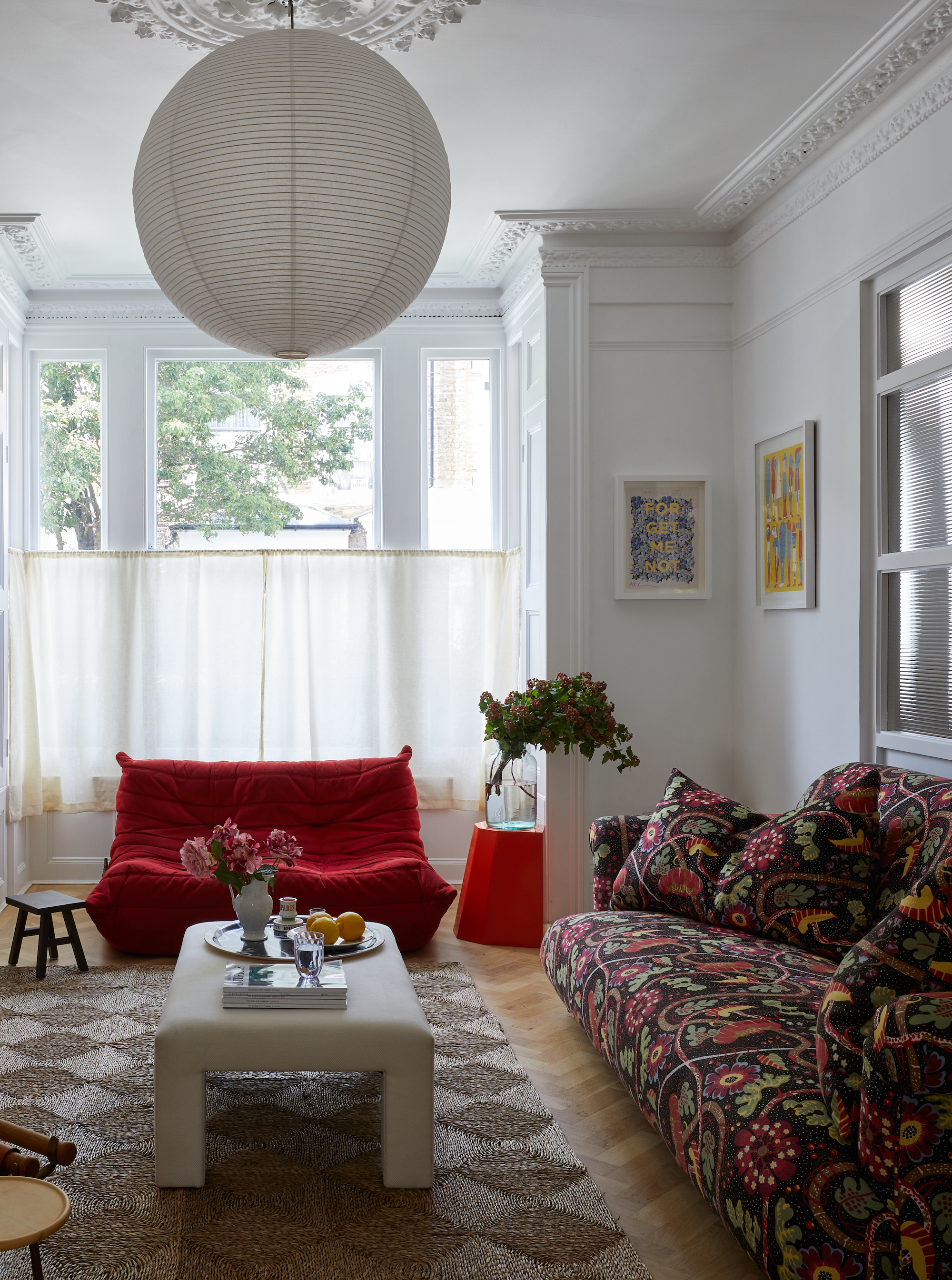 patterned sofa and red armchair