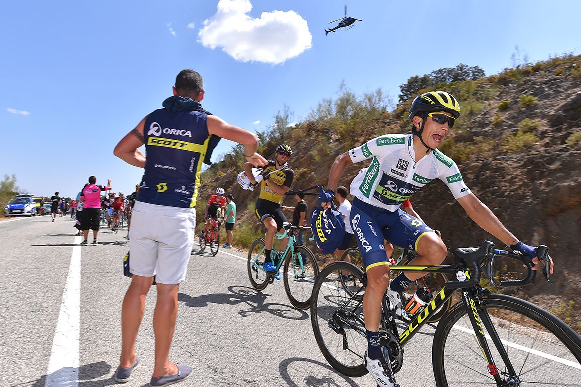 Esteban Chaves passes through the feed zone
