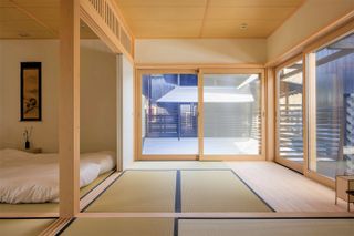 minimalist bedroom at Shishi-iwa House by Ryue Nishizawa