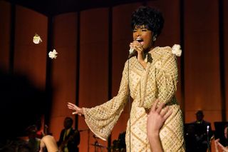 Jennifer Hudson wears a gold dress and sings as Aretha Franklin in 'Respect'