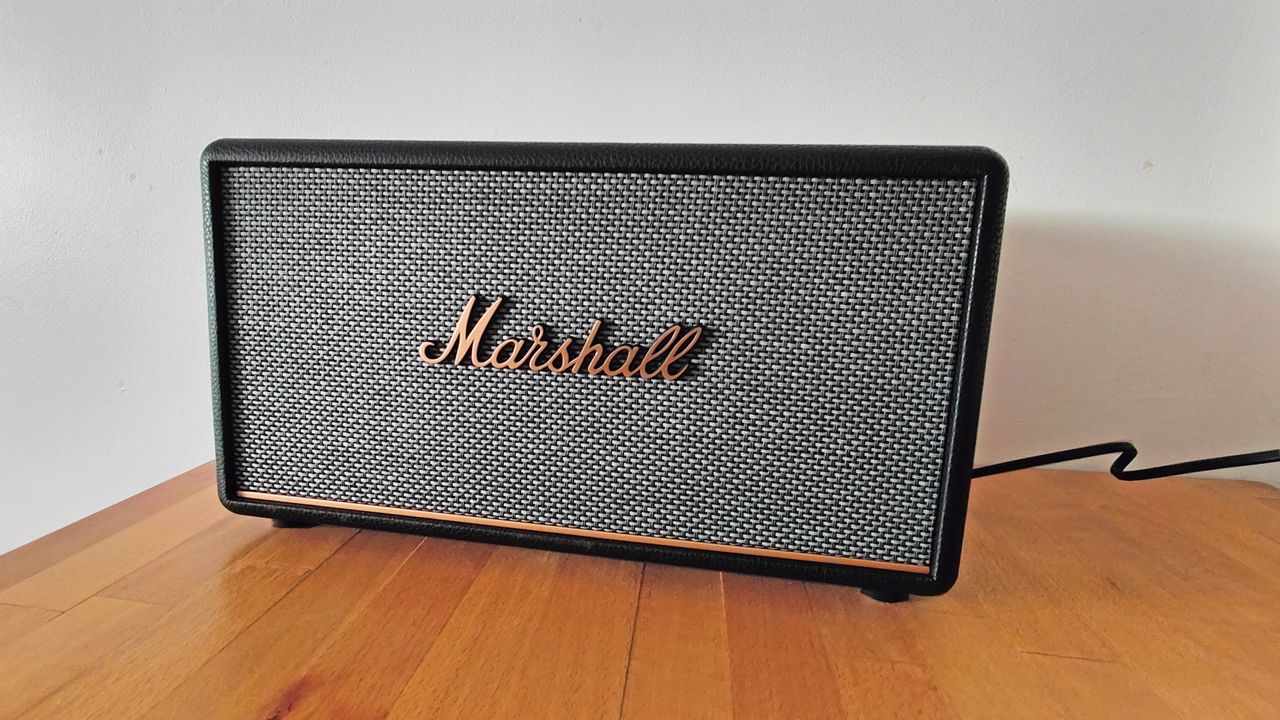 Marshall Stanmore III review: speaker on wooden table next to a white wall