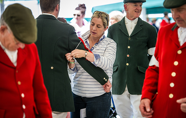 Tying on ribbons following success in the ring at the Great Yorkshire Hound Show