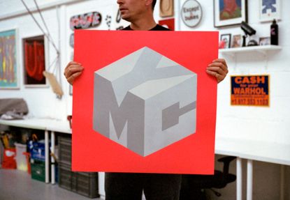 Artist Pref holding his new logo design for YMC