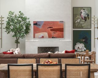 living space brown corner sofa, rattan dining chairs and abstract artwork on walls