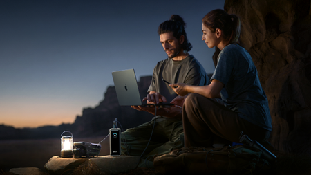 Image of two people in the wild using an Prime Power Bank - image is AI generated