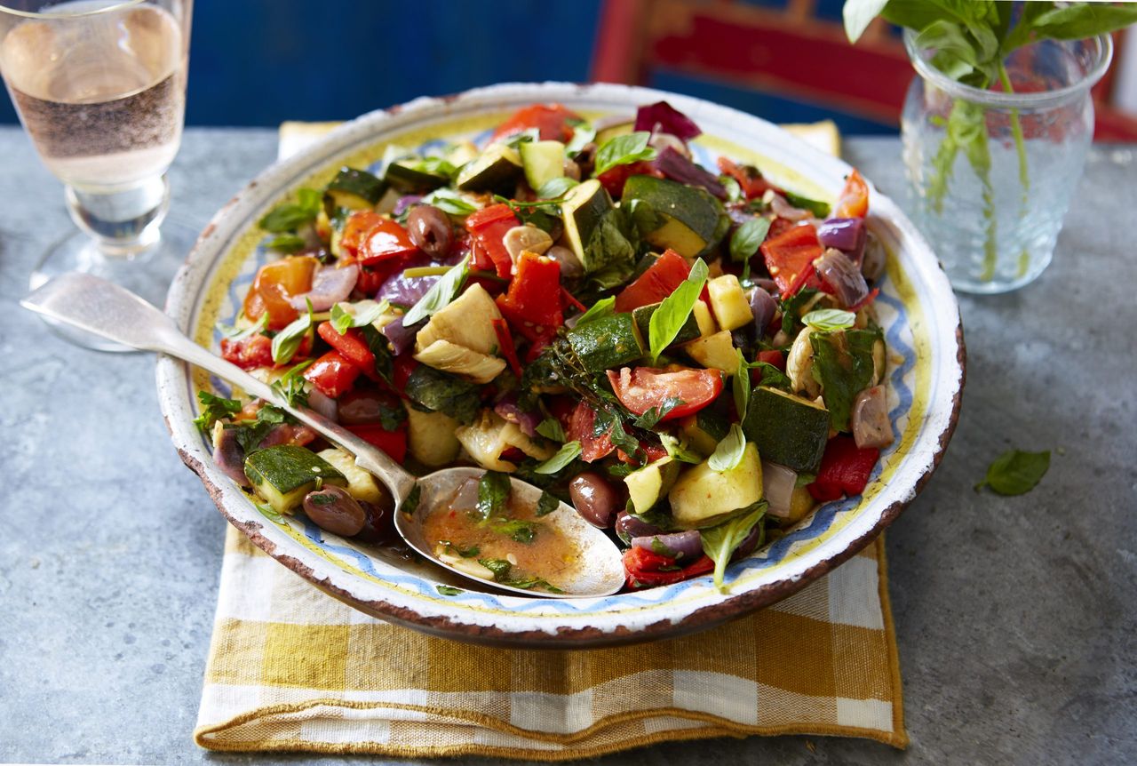 Bowl of ratatouille with spoon on a napkin