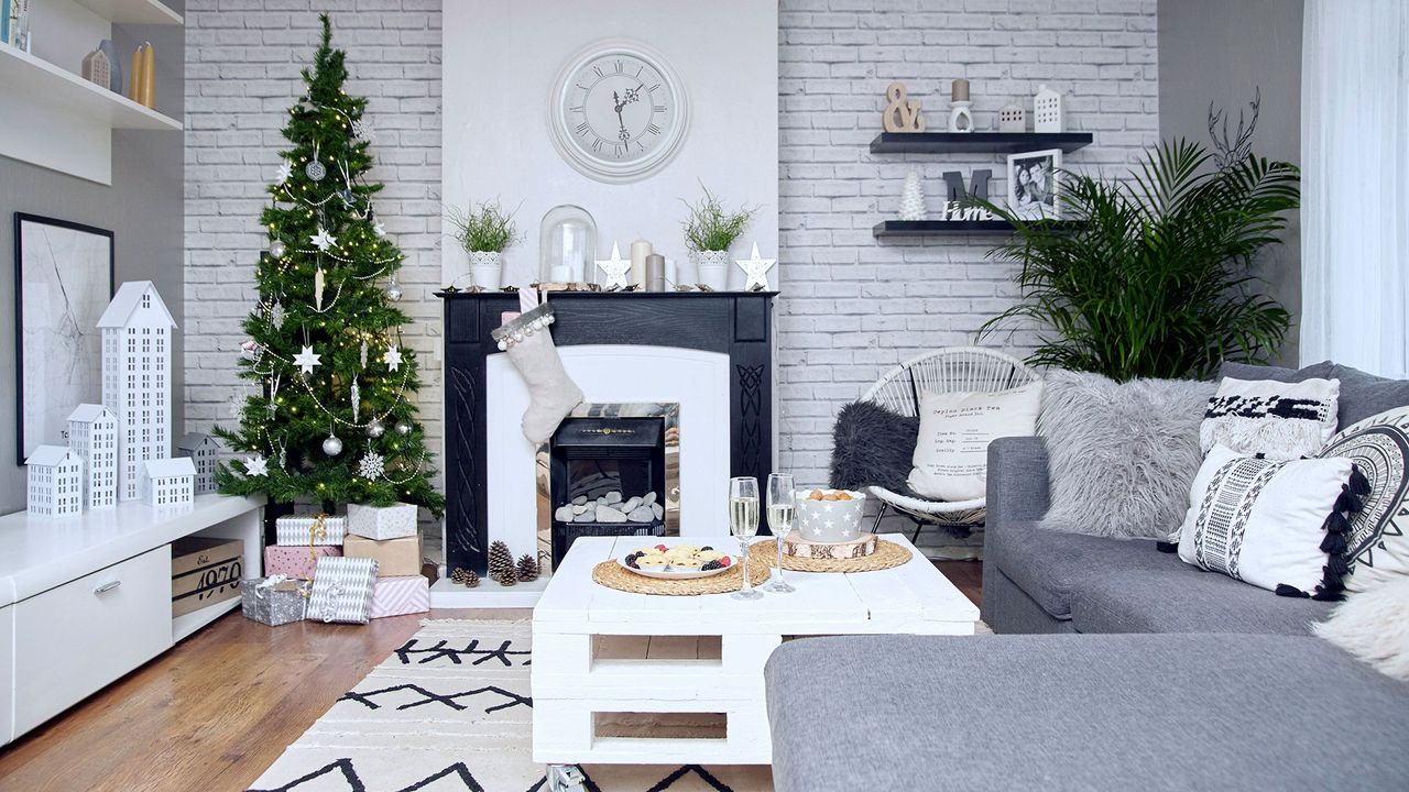 living room with grey sofa and christmas tree