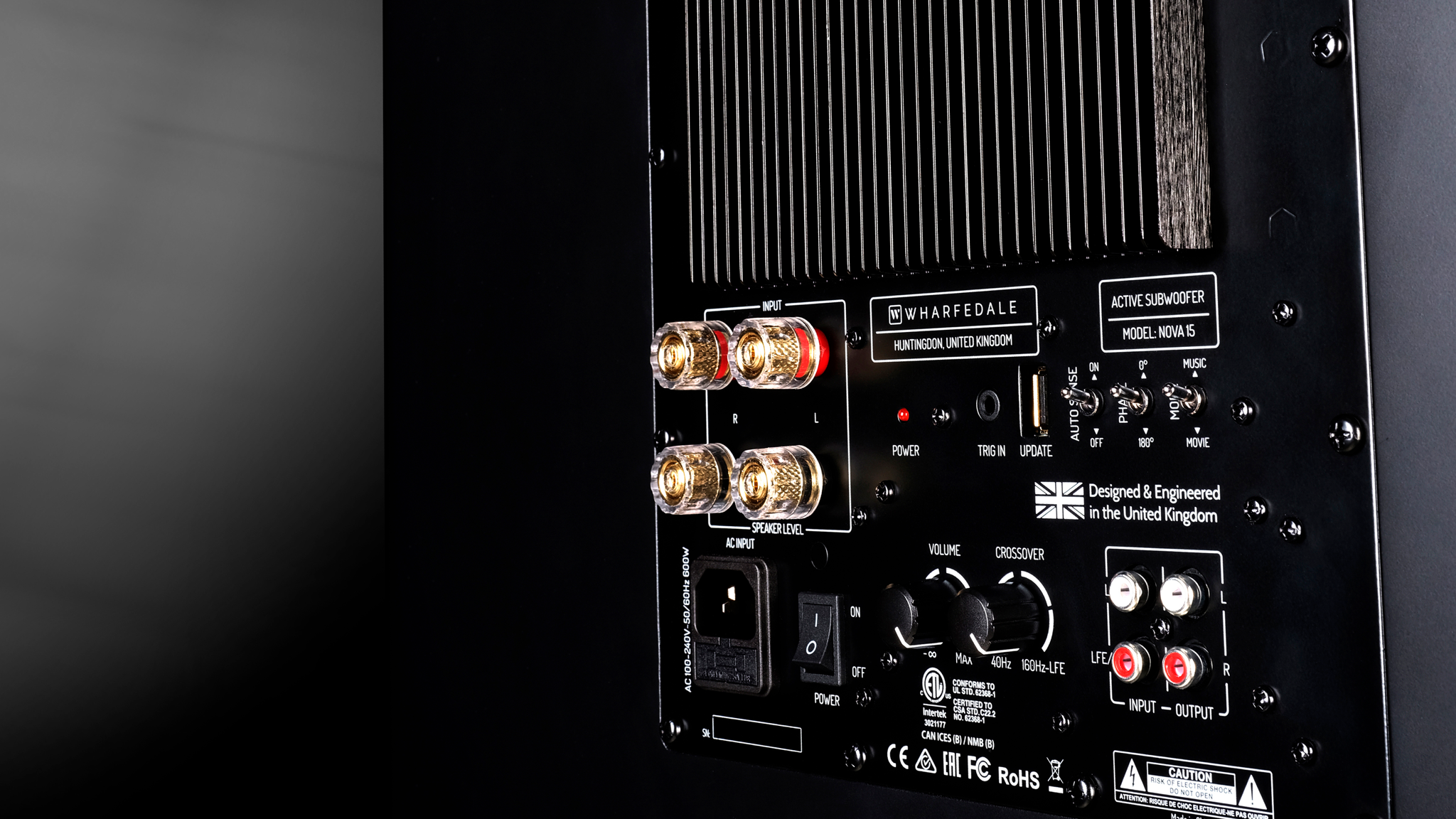 Rear view of the Wharfedale Nova 15 showing its connections and controls on a dark gradient background
