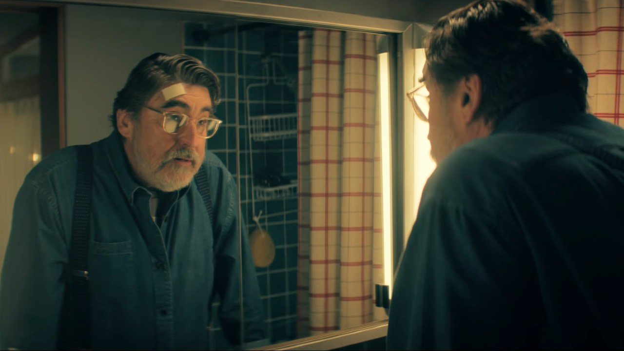 Alfred Molina as Sam looking in the mirror in the final scene of The Boroughs.