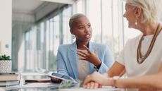 An adviser and client talk in an office.