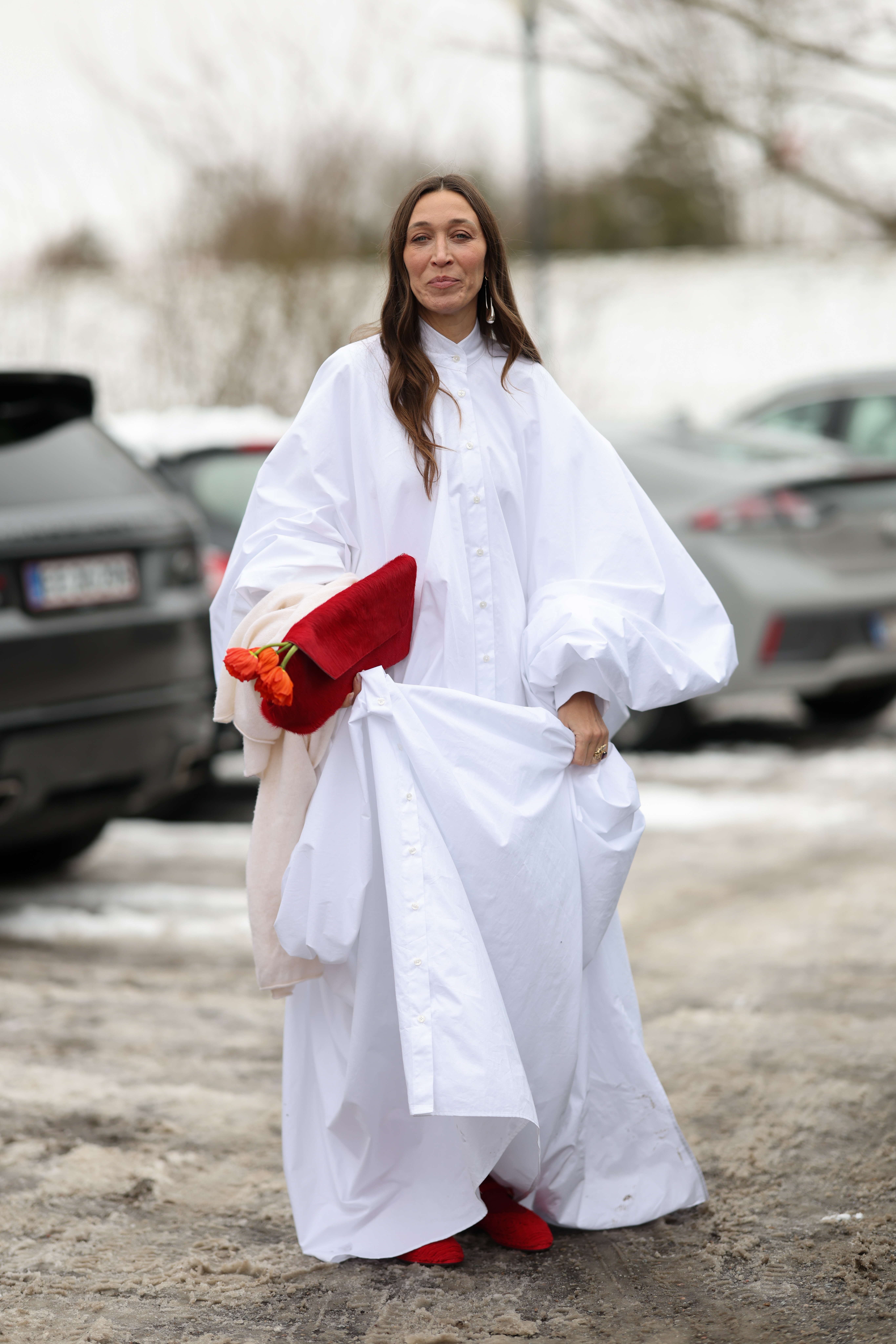 a woman wearing a white shirt dress with balloon sleeves in street style