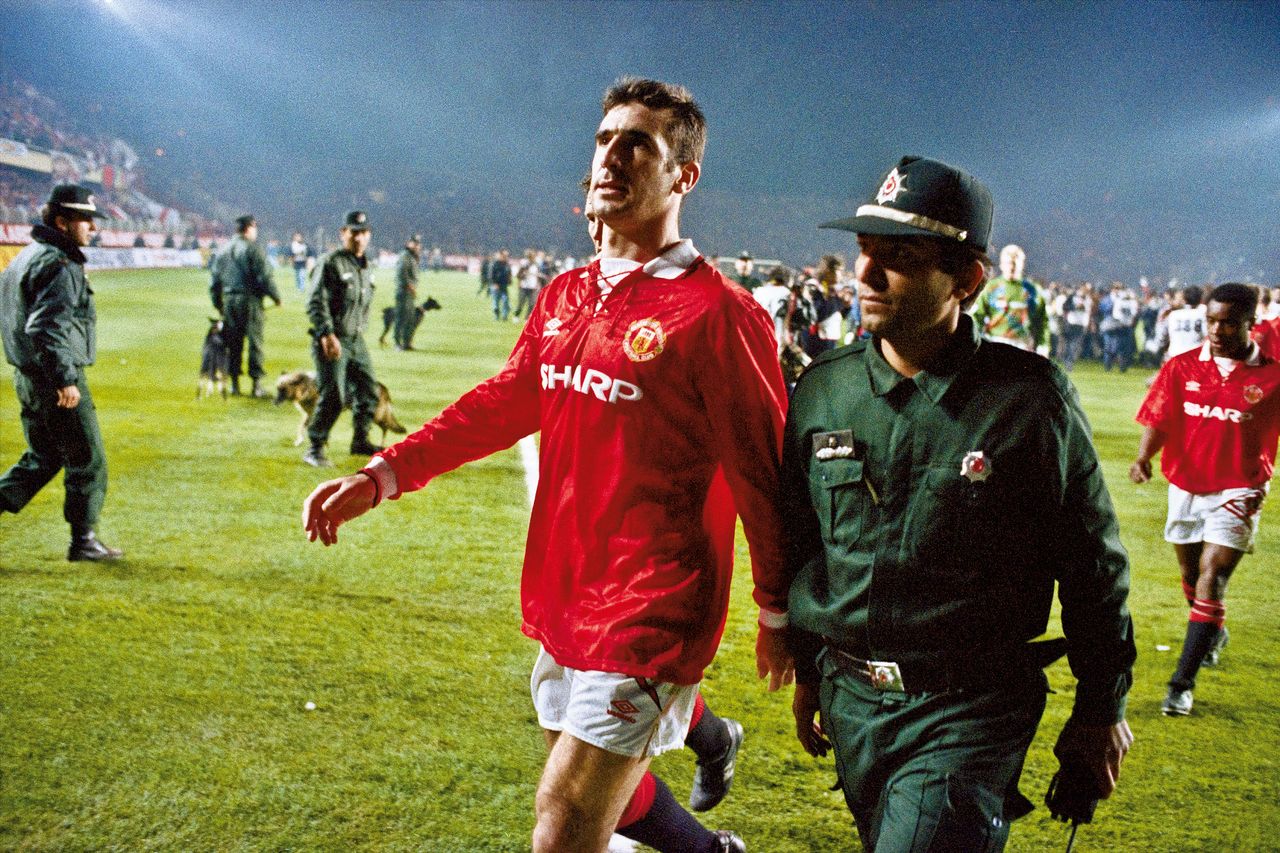Eric Cantona is escorted off the pitch by a Turkish policeman after being shown a red card against Galatasaray in November 1993.