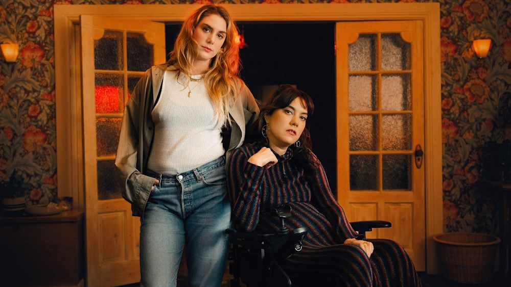 Elena Saurel as Jo and Kyla Harris as Freya looking at the camera in a promotional photo for We Might Regret This