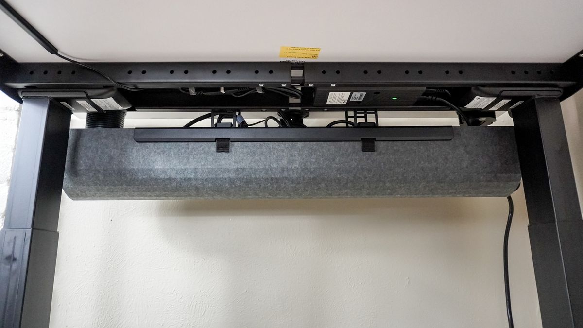 An under desk shot showing off the Uplift V3 standing desk's new cable management tray