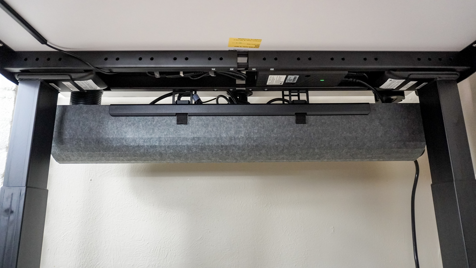 An under desk shot showing off the Uplift V3 standing desk's new cable management tray
