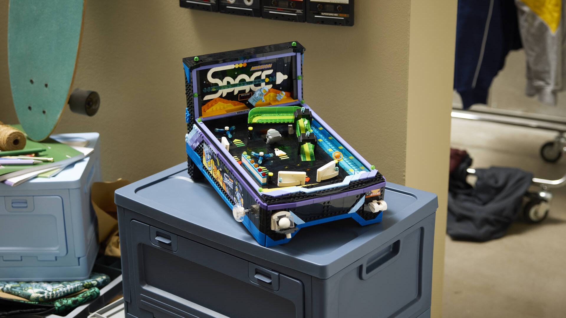 Lego Arcade Pinball Machine on a gray box in a messy bedroom