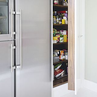 fridge freezer with storage unit and cupboard