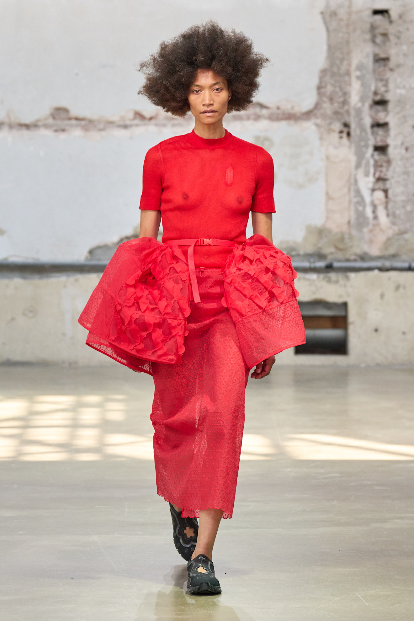 A model wore tomato red on Cecilie Bahnsen's Spring 2026 runway
