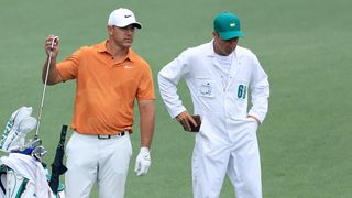 Brooks Koepka and caddie Ricky Elliott during a practice round before the 2023 Masters