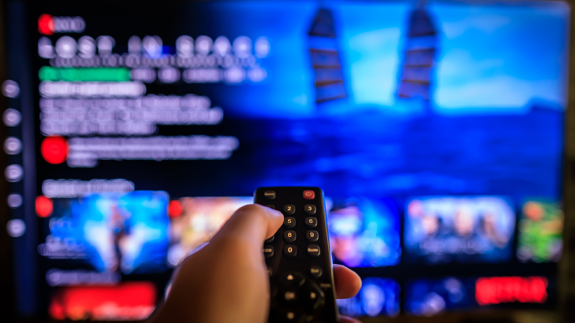 man using remote control with netflix