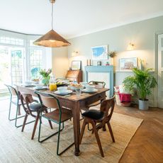 dining room with wood table and chairs and a blue fireplace