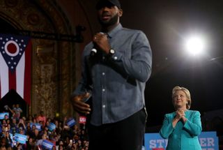 Looking on as LeBron James speaks during a rally in Cleveland.