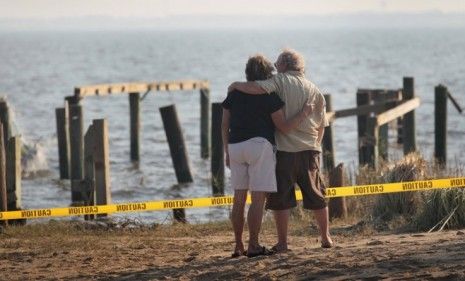 Residents view the remains of a Nags Head, N.C., cottage destroyed by Hurricane Irene on Saturday: The storm&amp;#039;s total damage, including lost economic activity, is estimated to be $40 billion.