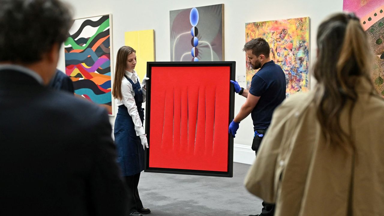 A piece by the late artist Lucio Fontana is seen during an auction photocall at Sotheby&#039;s.