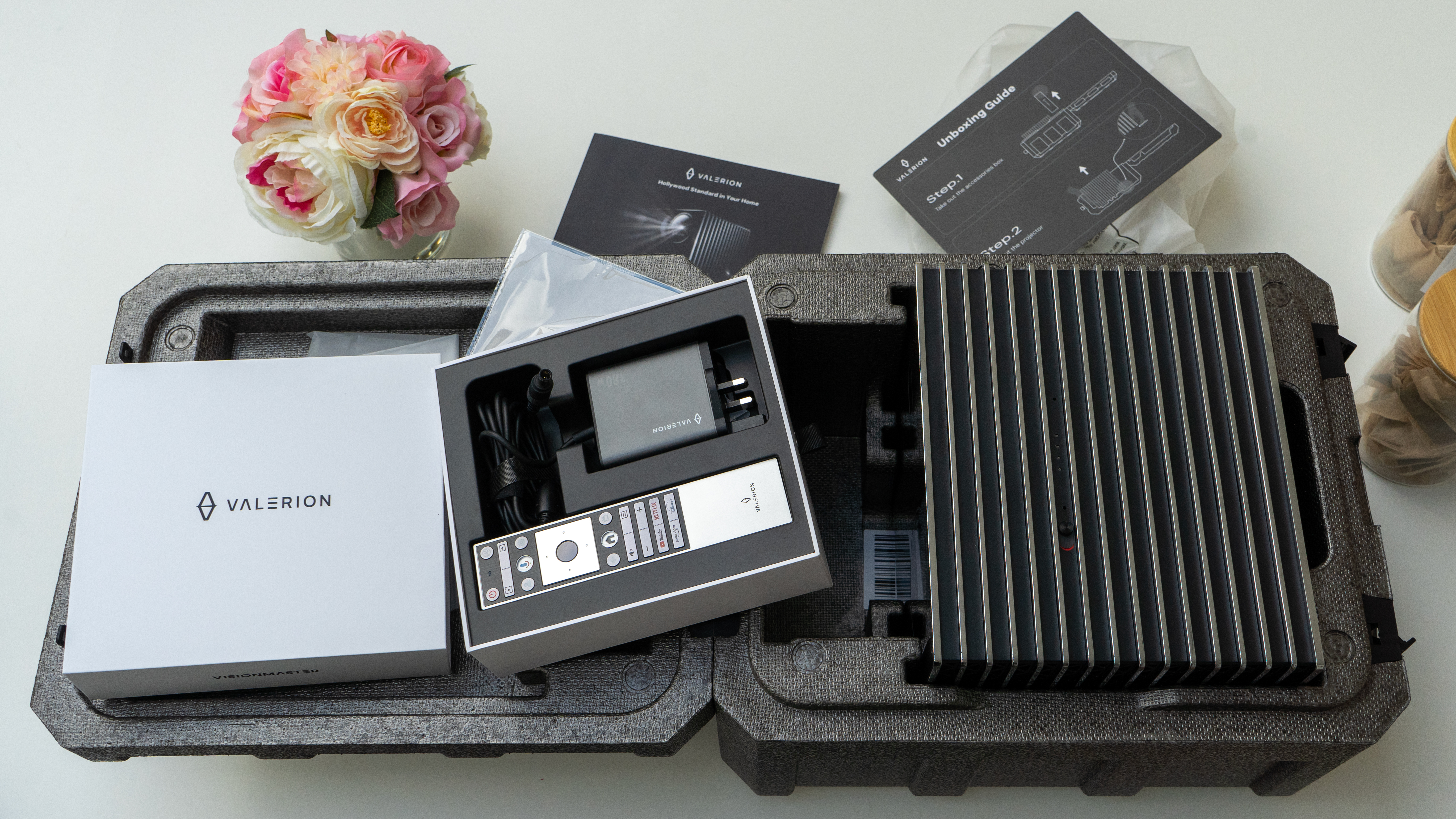Unboxing the Valerion VisionMaster Pro 2 projector on the counter – box open and accessories box opened but projector still in the case