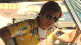 Brad Pitt as Rick Dalton looking out side window in Once Upon A Time In Hollywood