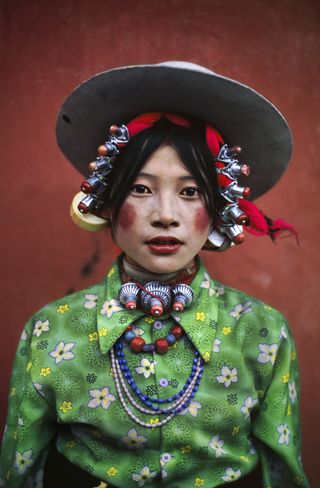 A colorful village girl participates in a rural horse festival in Eastern Tibet, 1999.
