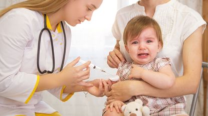 doctor giving a crying child an injection © Getty Images/iStockphoto