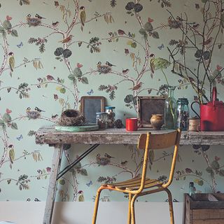 brid wallpaper wall with table and yellow chairs