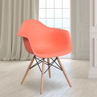 Coral colored chair with armrests sitting in a room