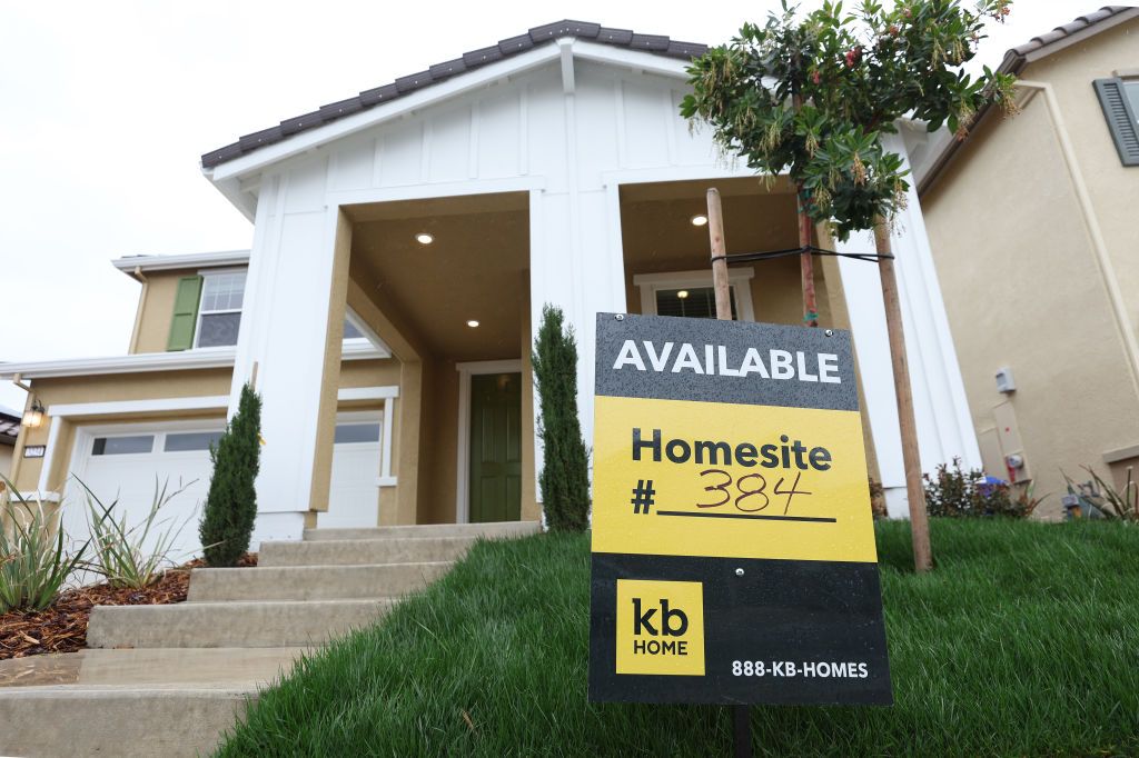 An &quot;Available&quot; sign in front of a house in a KB Home development