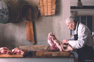 A man in Italy prepares a recently slaughtered pig