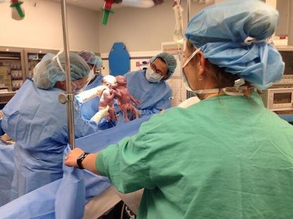 Rare twins born holding hands, just in time for Mother's Day